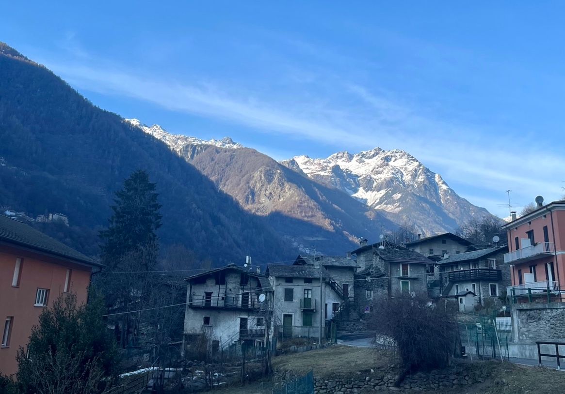 Snow-capped mountains form the backdrop of this village near Sondrio, Italy.