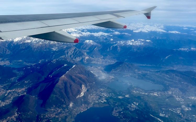 A view from a plane window of Lake Como and the Swiss Alps.