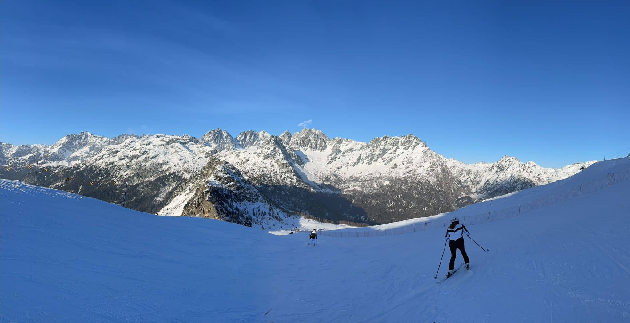 Skiiers on a groomed slope.