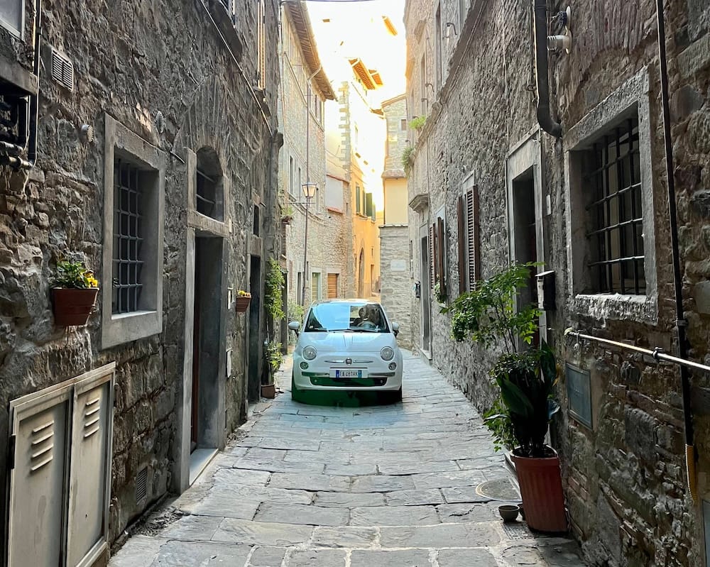 A narrow, winding street in Cortona, Italy.